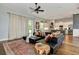 Cozy living room with area rug, dark sofa and view to the kitchen at 1357 Liam Cir, Ormond Beach, FL 32174