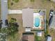 Drone eye view of backyard pool, patio, and well-manicured backyard at 2 Wildwood Dr, Edgewater, FL 32132
