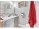 Bathroom with grey vanity, mounted shelves, and a neutral color scheme at 2 Wildwood Dr, Edgewater, FL 32132