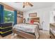 Bright bedroom with a comfortable bed, modern ceiling fan, and a window with a view of the backyard at 2 Wildwood Dr, Edgewater, FL 32132