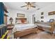 Bright bedroom with wood furniture, a modern ceiling fan, and large windows bringing in natural light at 2 Wildwood Dr, Edgewater, FL 32132