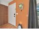 Foyer view featuring an orange wall and wood flooring at 2 Wildwood Dr, Edgewater, FL 32132