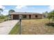 Charming brick home featuring an attached garage and a well-maintained front yard at 2 Wildwood Dr, Edgewater, FL 32132