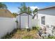 Property featuring a shed located in the backyard and surrounded by a white fence at 2 Wildwood Dr, Edgewater, FL 32132