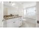 Bathroom featuring granite countertops, white cabinets and glass enclosed shower at 3074 Ocean Shore Blvd, Ormond Beach, FL 32176