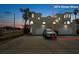 Inviting Mediterranean-style home with a spacious driveway and two-car garage at dusk at 3074 Ocean Shore Blvd, Ormond Beach, FL 32176