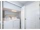 Efficient laundry area with white washer and dryer, plus ample storage at 3074 Ocean Shore Blvd, Ormond Beach, FL 32176