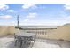 Rooftop patio featuring an ocean view and an outdoor dining set at 3074 Ocean Shore Blvd, Ormond Beach, FL 32176