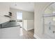 Wet bar with sink next to window and door leading to rooftop patio at 3074 Ocean Shore Blvd, Ormond Beach, FL 32176