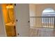 Upstairs bathroom vanity, pedestal sink, and a railing overlooking a balcony at 3076 Ocean Shore Blvd, Ormond Beach, FL 32176