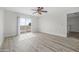 Bedroom area with wood-look flooring, a ceiling fan, and a sliding glass door that leads to a balcony at 3076 Ocean Shore Blvd, Ormond Beach, FL 32176