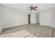 A spacious bedroom featuring stylish wood floors and a classic ceiling fan fixture at 3076 Ocean Shore Blvd, Ormond Beach, FL 32176
