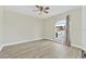 Bright bedroom featuring wood-look flooring and a large arched window with natural light at 3076 Ocean Shore Blvd, Ormond Beach, FL 32176