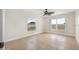 Bedroom featuring many windows for natural light, a ceiling fan, and wood-look tile flooring at 3076 Ocean Shore Blvd, Ormond Beach, FL 32176