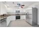 Bright kitchen with stainless steel appliances, granite counters, and ample cabinet space at 3076 Ocean Shore Blvd, Ormond Beach, FL 32176