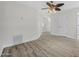 Loft area with neutral walls, wood-look flooring, a ceiling fan, and access to other rooms at 3076 Ocean Shore Blvd, Ormond Beach, FL 32176