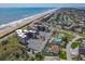 Breathtaking aerial showcasing the proximity of the beach, condos, tennis court, and swimming pool at 3370 Ocean Shore Blvd # 205-B, Ormond Beach, FL 32176