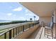 Balcony overlooking the ocean, street, and vegetation, with seating for relaxation at 3370 Ocean Shore Blvd # 205-B, Ormond Beach, FL 32176
