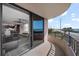 Condo balcony overlooking ocean with black railing, and an open floor plan showing the living room and kitchen at 3370 Ocean Shore Blvd # 205-B, Ormond Beach, FL 32176