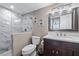 Bathroom featuring a modern vanity and a stand-up shower with marble surround at 3370 Ocean Shore Blvd # 205-B, Ormond Beach, FL 32176