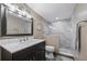 Modern bathroom with marble-tiled shower and vanity with marble countertop at 3370 Ocean Shore Blvd # 205-B, Ormond Beach, FL 32176