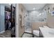 Bathroom and walk-in closet with a modern vanity, stand-up shower with marble surround and lots of clothes at 3370 Ocean Shore Blvd # 205-B, Ormond Beach, FL 32176