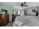 Bedroom featuring wooden-look floors, ceiling fan, and television at 3370 Ocean Shore Blvd # 205-B, Ormond Beach, FL 32176