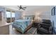 Bedroom with wood floors, a ceiling fan, and a balcony with a view of the ocean at 3370 Ocean Shore Blvd # 205-B, Ormond Beach, FL 32176