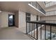 Condo hallway featuring dark trim and neutral-toned walls, leading to unit door at 3370 Ocean Shore Blvd # 205-B, Ormond Beach, FL 32176