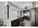 Spacious kitchen with a large island, stainless steel appliances, and dark cabinets at 3370 Ocean Shore Blvd # 205-B, Ormond Beach, FL 32176