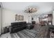 Living room with comfortable seating, modern fan, wood-look tile, open concept into kitchen and dining at 3370 Ocean Shore Blvd # 205-B, Ormond Beach, FL 32176