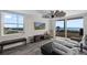 Bright living room with ocean views, modern ceiling fan, wood-look tile, and sliding glass doors to balcony at 3370 Ocean Shore Blvd # 205-B, Ormond Beach, FL 32176