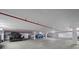 Underground parking garage with multiple cars and assigned parking spots for secure and convenient resident parking at 3370 Ocean Shore Blvd # 205-B, Ormond Beach, FL 32176