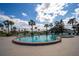 Community pool with lounge chairs and palm trees for a relaxing outdoor experience at 3370 Ocean Shore Blvd # 205-B, Ormond Beach, FL 32176