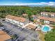 Aerial view of complex showing amenities, parking and surrounding trees and foliage at 420 Banana Cay Dr # A, South Daytona, FL 32119