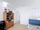 Clean bedroom with a twin bed, white walls, and access to the hallway at 420 Banana Cay Dr # A, South Daytona, FL 32119