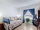 Bedroom featuring a twin bed, blue curtains, and a built-in bookshelf at 420 Banana Cay Dr # A, South Daytona, FL 32119