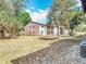 Exterior view of condo with expansive backyard, lush trees, and privacy fence at 420 Banana Cay Dr # A, South Daytona, FL 32119