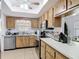 Kitchen with wood cabinets, stainless steel appliances, and ample counter space at 420 Banana Cay Dr # A, South Daytona, FL 32119