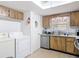 Multi-purpose area with washer, dryer, kitchen with ample cabinet space and stainless steel appliances at 420 Banana Cay Dr # A, South Daytona, FL 32119