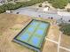 Aerial view of tennis and basketball courts nestled among lush greenery at 44 Sandra Dr, Ormond Beach, FL 32176