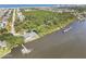 Expansive aerial shot showcasing waterfront property with private dock, lush landscaping, and neighborhood view at 44 Sandra Dr, Ormond Beach, FL 32176