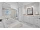 Bright bathroom featuring a jetted tub, walk-in shower and modern vanity with a vessel sink at 44 Sandra Dr, Ormond Beach, FL 32176