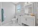 Well-lit bathroom with updated vanity, seashell decor, and coastal charm at 44 Sandra Dr, Ormond Beach, FL 32176