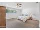 This bedroom features neutral carpet, one window and ceiling fan at 44 Sandra Dr, Ormond Beach, FL 32176