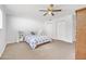 Cozy bedroom features neutral carpet, ceiling fan, and standard closets at 44 Sandra Dr, Ormond Beach, FL 32176