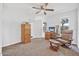 Cozy bedroom featuring a ceiling fan, windows, and comfortable seating area at 44 Sandra Dr, Ormond Beach, FL 32176