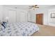 Well-lit bedroom with neutral carpet, ceiling fan, and closet doors at 44 Sandra Dr, Ormond Beach, FL 32176