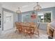 Dining area with tile floor, natural wood table, and access to exterior at 44 Sandra Dr, Ormond Beach, FL 32176