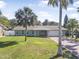 Charming single-story home with lush lawn and mature palms in a sunny, tropical setting at 44 Sandra Dr, Ormond Beach, FL 32176
